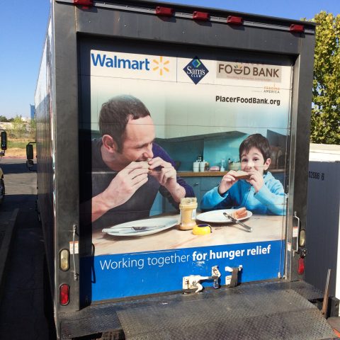 A truck with a billboard advertising food bank.