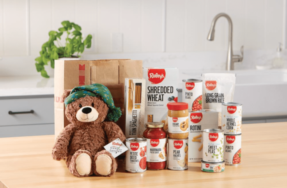 A brown teddy bear sitting on top of a table.